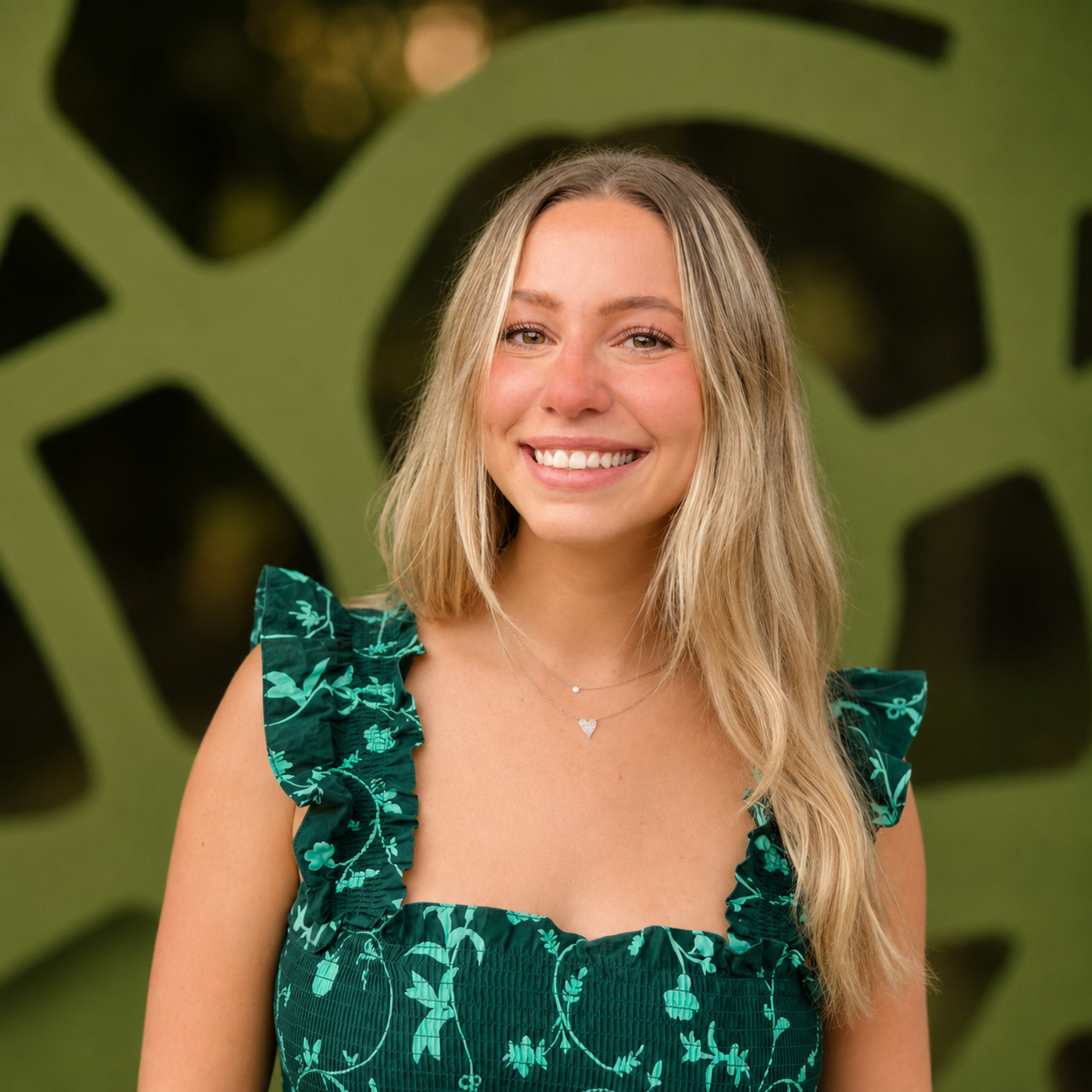 Kate Schramm, MSW, LCSW, Clinical Director and Therapist, smiling in a green dress